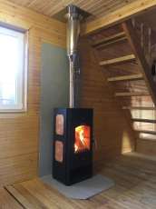 Популярный камин с дровницей Сибирь 8 в интерьере фото в Витебске